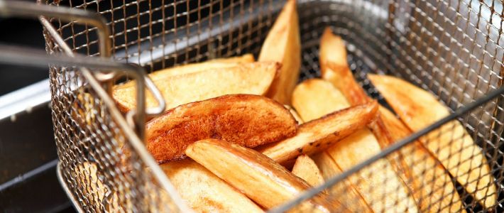 potatoes frying in a deep fat fryer